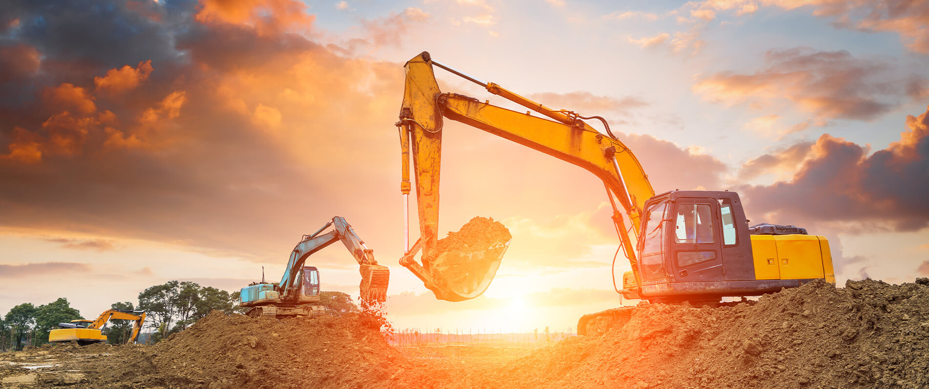 An image excavtors in a sunset
