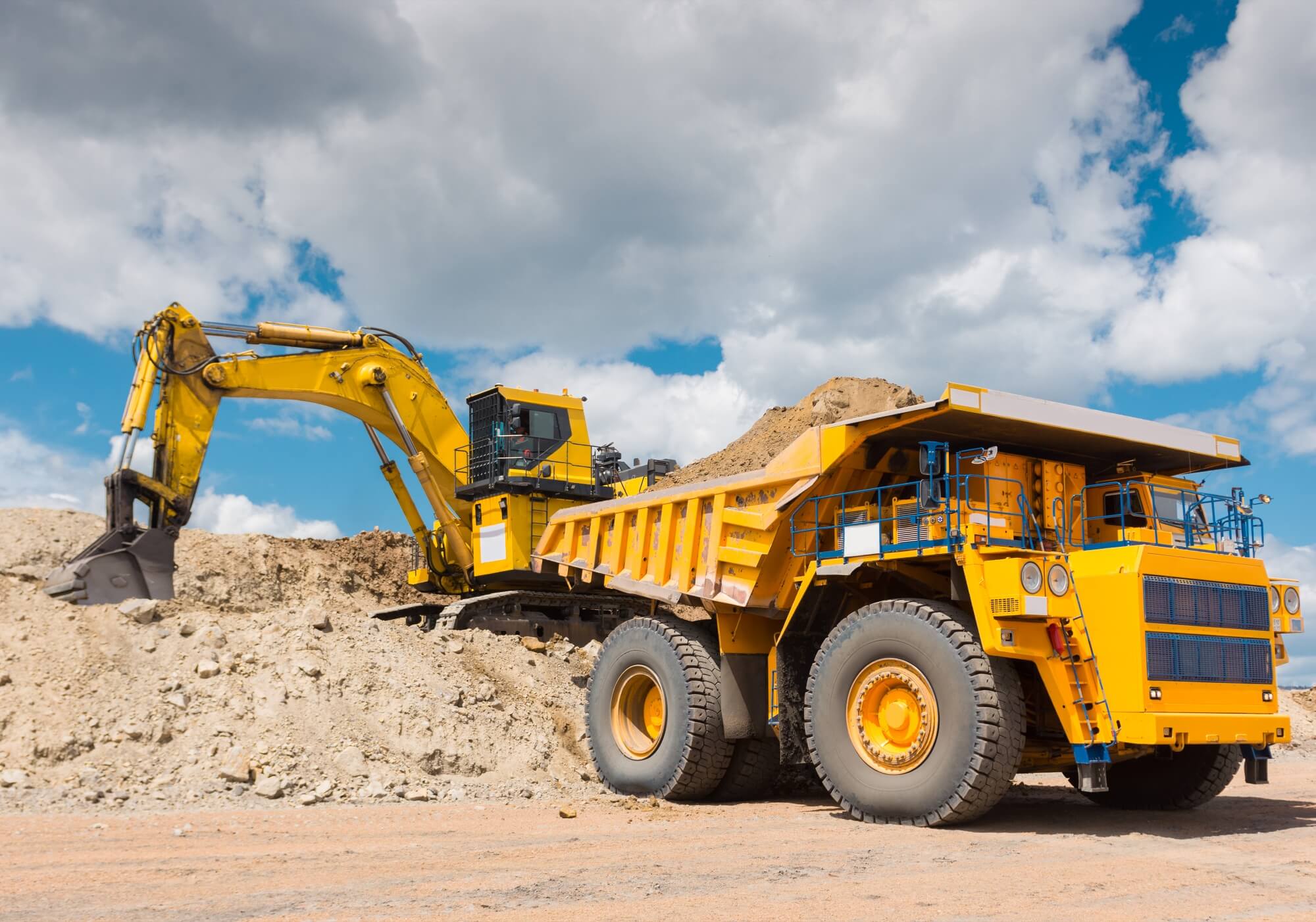 dozer pushing a pile of rocks